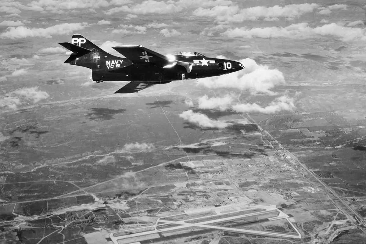 Historic aerial view of Miramar airfield with a Navy reconnaissance aircraft